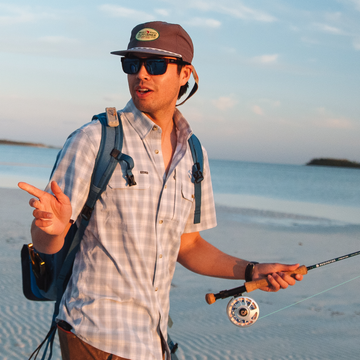 Man wearing blue plaid button down fishing shirt