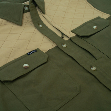 Close-up of olive green and tan quilted outdoor shirt called The Roosevelt with buttoned pockets