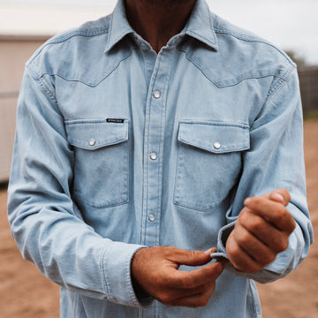 man wearing light blue denim shirt