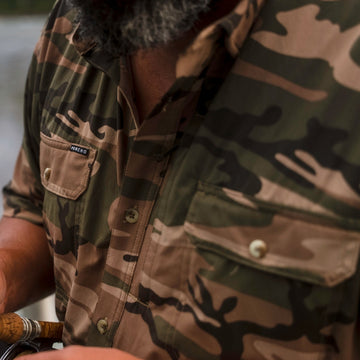 Close-up of camo shirt with pockets from The Asado collection outdoors