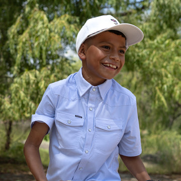 kid wearing blue pearl snap short sleeve shirt