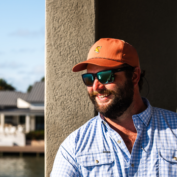Man smiling while wearing The Bull Red Hat