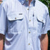 The Cattleman white grid pattern short sleeve shirt with brass buttons outdoors