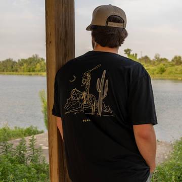 man wearing the cowboy moon tee
