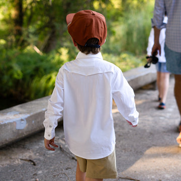 Back of kid's white pearl snap shirt