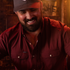 man smiling wearing maroon shirt