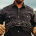 man holding barbed wire wearing the matamorros shirt