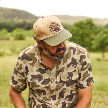 Man wearing Eagle and Trout Hat in outdoor natural setting