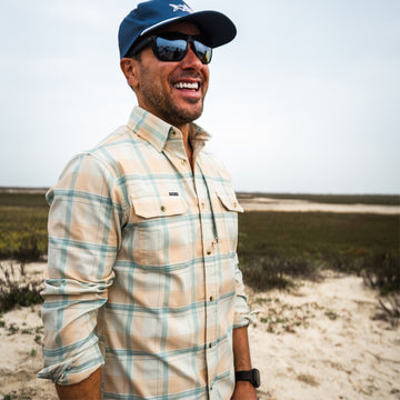 Man smiling outdoors wearing The Encinitas plaid comfortable outdoor shirt