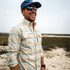 Man smiling outdoors wearing The Encinitas plaid comfortable outdoor shirt