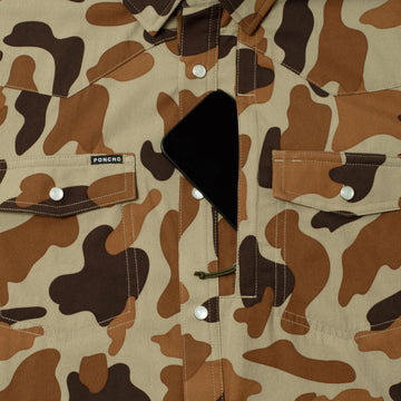 Close-up of The White Wing shirt in brown camouflage pattern with snap buttons and chest pockets, highlighting a hidden smartphone pocket.