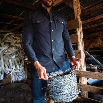 man holding barbed wire wearing black long sleeve shirt