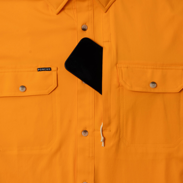Bright orange button-up shirt with front pockets and phone in hidden chest pocket from The First and Goal collection
