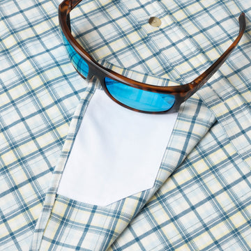 sunglasses with lens cleaner on shirt