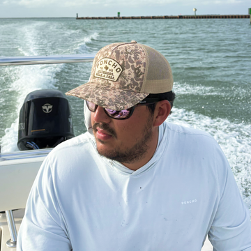 man on boat wearing the game hat