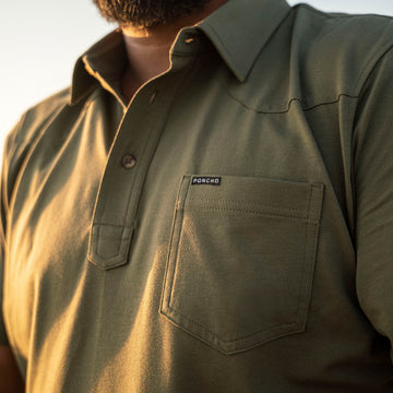 man wearing green polo shirt