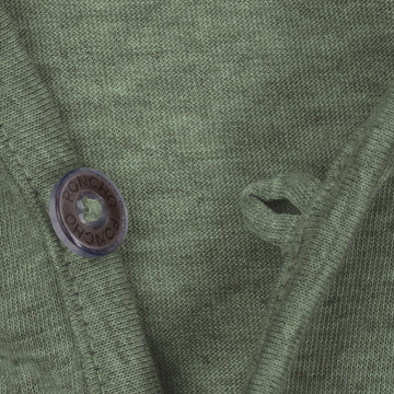 Close-up of moss green breathable shirt fabric with button and loop detail from The Boundary Waters