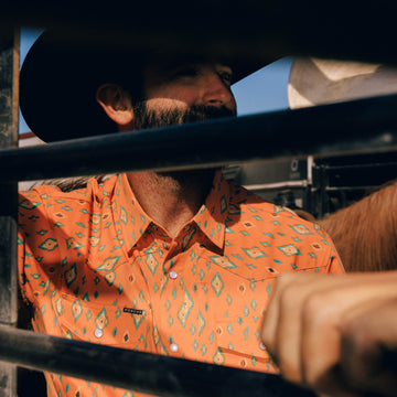Guy hanging out by horse trailer in The Bisbee shirt