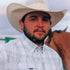 Man wearing The Billings outdoor shirt and cowboy hat standing near a horse
