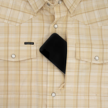Close-up of beige plaid shirt pocket holding a smartphone, featuring The Sweetwater outdoor shirt design