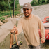 man handed fishing rods wearing warm sand hoodie
