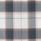 Close-up of fabric with gray, white, and orange plaid pattern