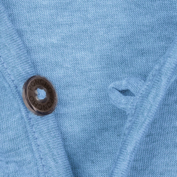 Close-up of blue breathable fabric and button on The Thousand Lakes outdoor shirt