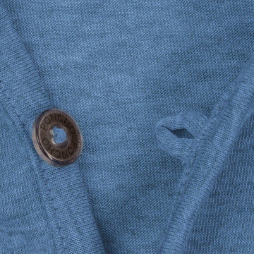 Close-up of blue knit fabric and button detail on The Blue Hole Bridge shirt