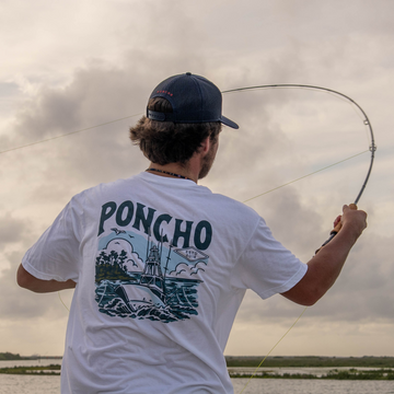 Man casting a fly rod while wearing The Sport Fisher T-shirt