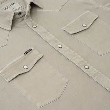 Close-up of beige outdoor shirt buttons and pockets from The Stockton collection by Poncho Outdoors