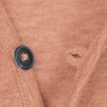 Close-up of a brown knit fabric with a black button labeled Poncho on The Rusty Pliers shirt