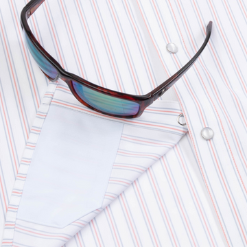 Closeup of sunglasses with lens cleaner on shirt