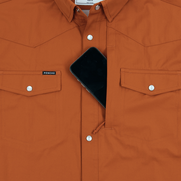 The 1969 rust orange shirt with snap pockets and phone in hidden chest pocket