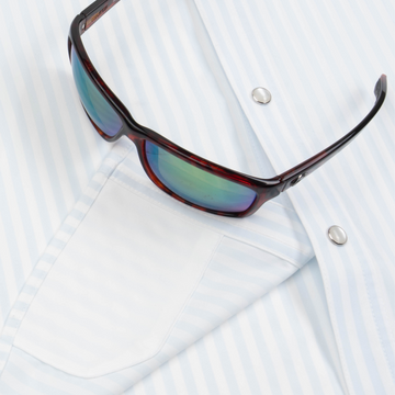 Closeup of sunglasses with lens cleaner on shirt
