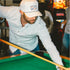 man shooting pool wearing the abaco shirt