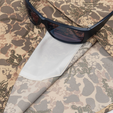sunglasses with lens cleaner on shirt