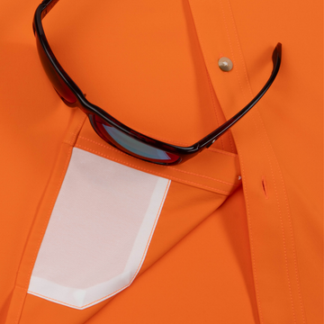 Closeup of sunglasses with lens cleaner on shirt