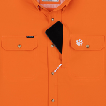 Phone in chest zipper pocket of shirt