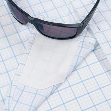 sunglasses with lens cleaner on shirt