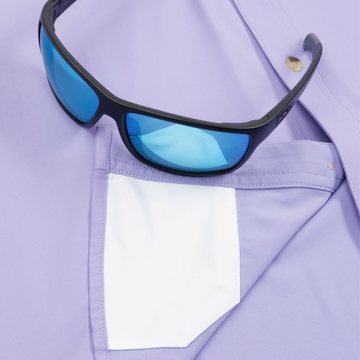 Closeup of sunglasses with lens cleaner on shirt