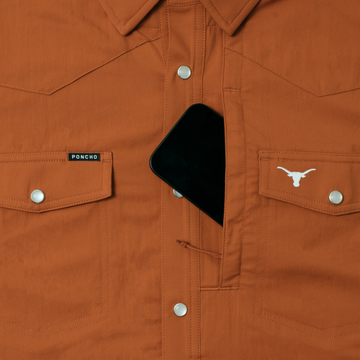 The Bertha shirt in burnt orange with secure chest pockets and snap buttons