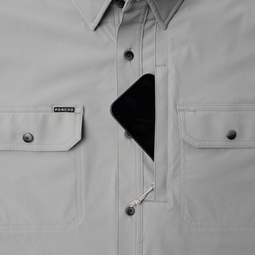 Phone in chest zipper pocket of shirt