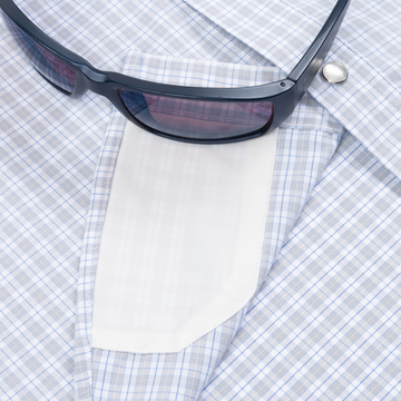 sunglasses with lens cleaner on shirt