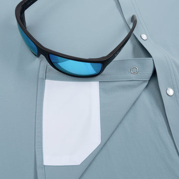 Closeup of sunglasses with lens cleaner on shirt