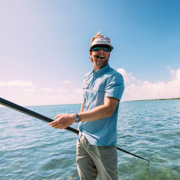 man holding pole wearing the biscayne shirt