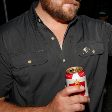 Close-up of a man wearing The Buff black outdoor shirt holding a beer can