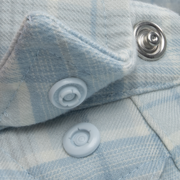 Close-up of light blue plaid fabric shirt buttons on The Cannon Beach shirt