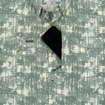 Phone in chest zipper pocket of shirt