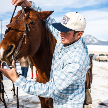 Man with horse wearing the cody flannel