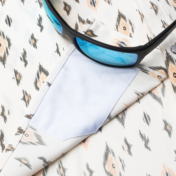 sunglasses with lens cleaner on shirt